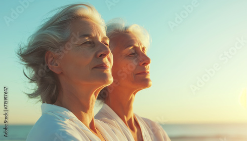 Portrait of two adult women relaxing on the beach. Concept of active age