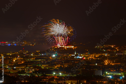 Fireworks over the night city of Brno in the Czech Republic in Europe. Above the city are different colored shapes of flares.