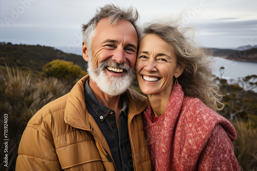 Affectionate senior couple embracing by the serene ocean, enjoying quality time together