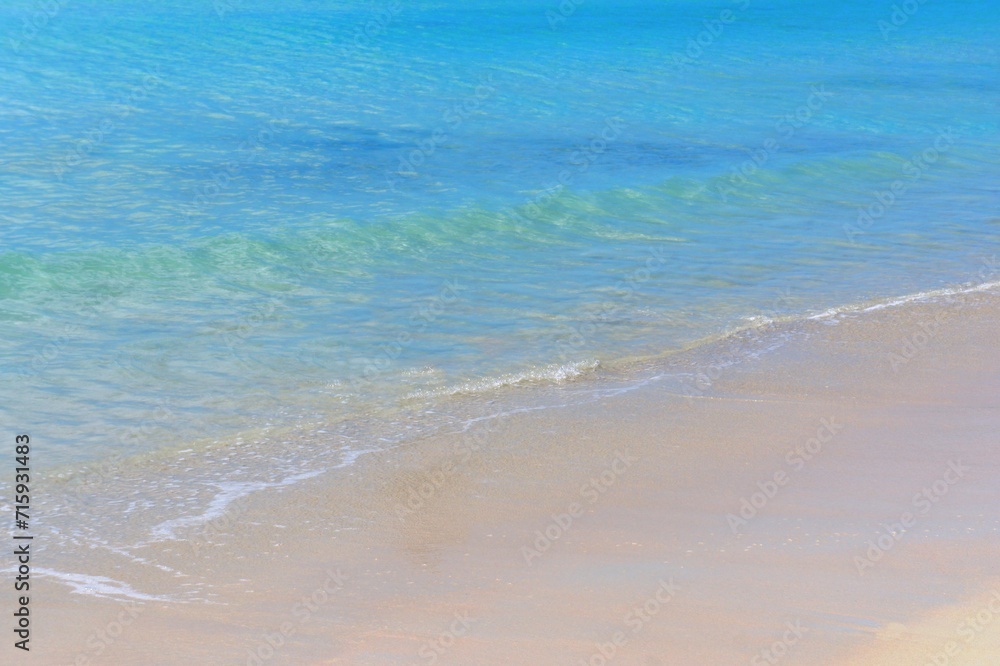 Blue ocean waves on sandy beach. 