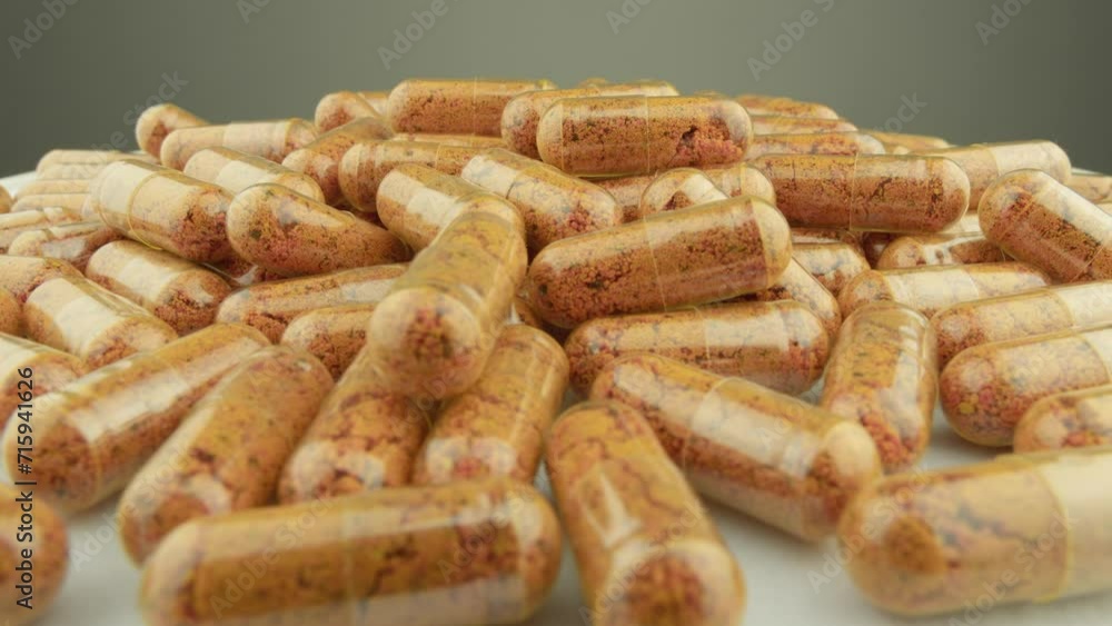 Demonstration of pharmaceuticals and nutritional supplements in the form of capsules on a white and gray background. Capsules with vitamins and nutrients are rotated to support a healthy lifestyle. Demonstration of pharmaceuticals and nutritional supplements in the form of capsules on a white and gray background. Capsules with vitamins and nutrients are rotated to support a healthy lifestyle.