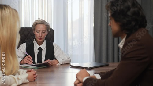 Wallpaper Mural Professional middle-aged businesswoman investment advisor lawyer financial expert consulting clients young couple holding document contract, negotiating explaining bank loan deal benefits Torontodigital.ca