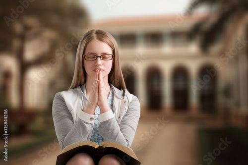 Portrait of young female praying to God for blessing