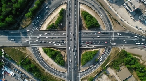 Aerial view of abstract roundabout intersection of city roads with cars on it