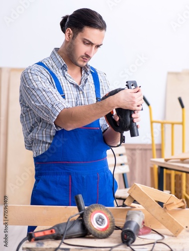 Young male carpenter working indoors