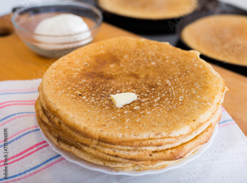 stack of appetizing flour pancakes in the kitchen during cooking