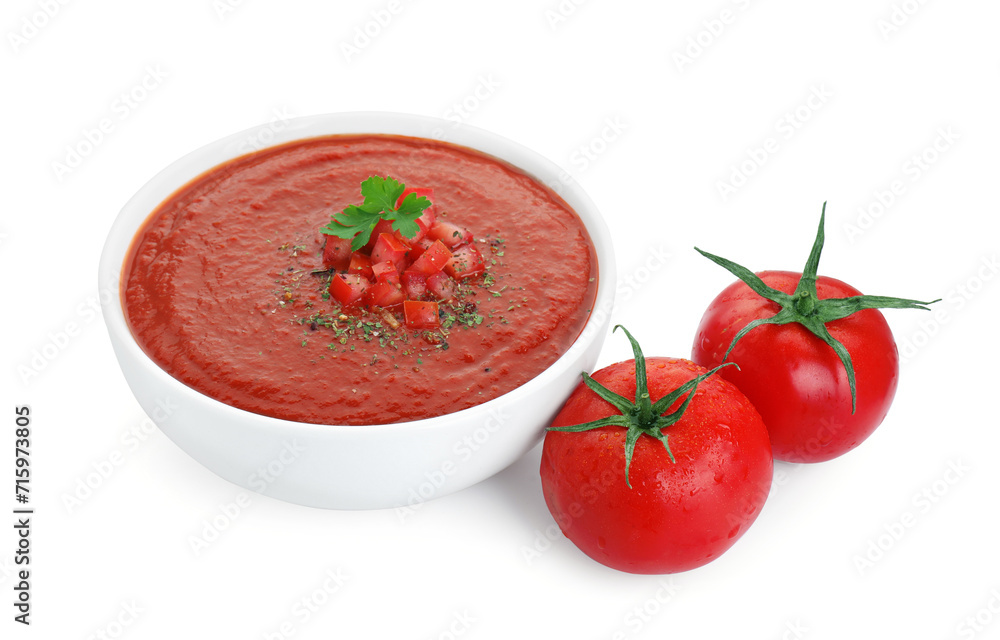 Delicious tomato cream soup in bowl and fresh tomatoes isolated on white Delicious tomato cream soup in bowl and fresh tomatoes isolated on white