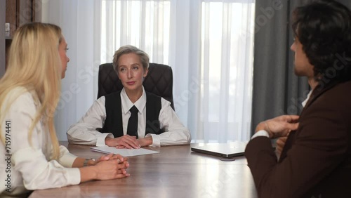Wallpaper Mural Rear view of successful businessman in suit giving money to grateful professional middle-aged female partner as reward for successful business contract, sitting at office desk. Shooting in slow motion Torontodigital.ca
