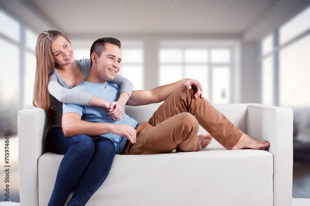 Happy smiling couple sitting together at home Happy smiling couple sitting together at home