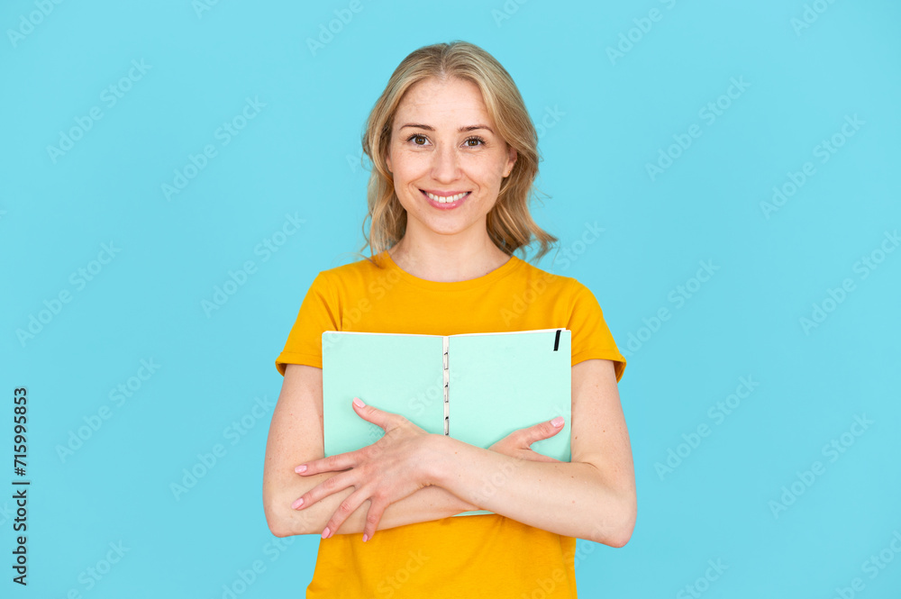 Happy student hug her personal copybook with creative ideas Happy student hug her personal copybook with creative ideas