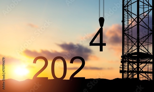 crane lifting 4 number to 2024 new year silhouette