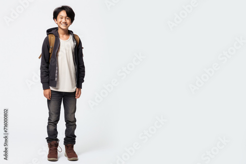 Asian chinese teenager boy with backpack over white background. Middle school smiling at camera Back to school. Copy space for advertising blank. Childhood, education, products for children