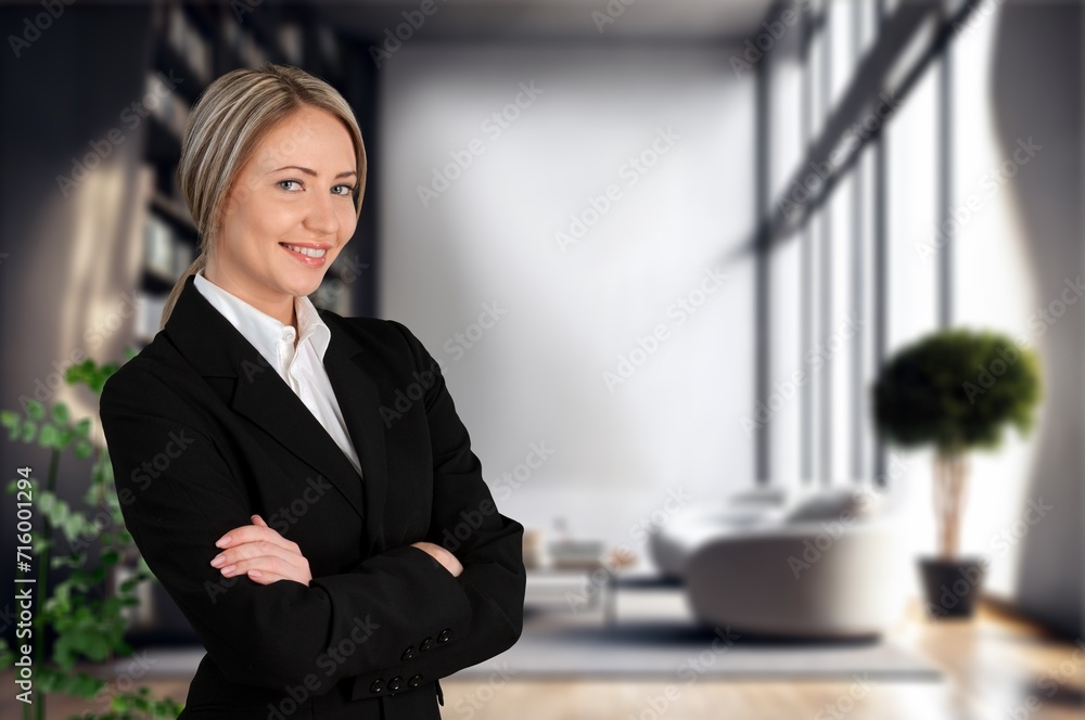 Happy professional business woman standing in office Happy professional business woman standing in office