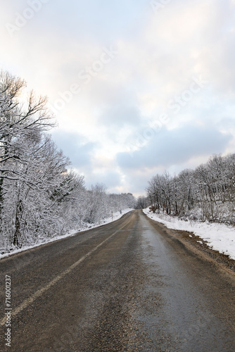 Snowy mountain roads. Road landscape in winter. Winter vacation concept. Road Leading Into Winter Mountain Landscape.