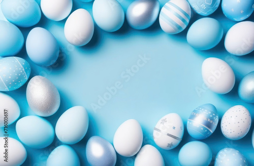 Colorful blue silver Easter eggs arranged in a flatlay, top-down perspective, with a generous copy space for your text or design.