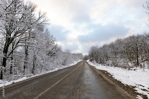 Snowy mountain roads. Road landscape in winter. Winter vacation concept. Road Leading Into Winter Mountain Landscape.