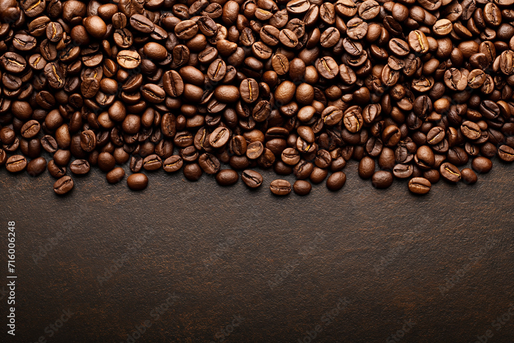 a lot of coffee beans lying on top of each other, for the background, top view, empty space from below a lot of coffee beans lying on top of each other, for the background, top view, empty space from below