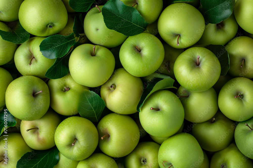 lots of green apples with leaves lying on top of each other, for background, top view lots of green apples with leaves lying on top of each other, for background, top view