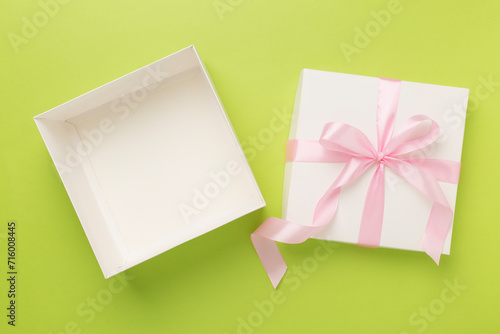 White open gift box on color background, top view. Mock up for design