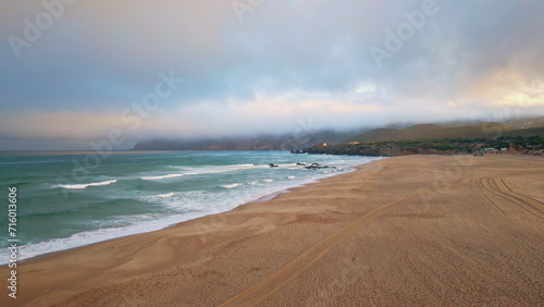 Gloomy sea surf evening nature in slow motion. Sunset with low hanging clouds