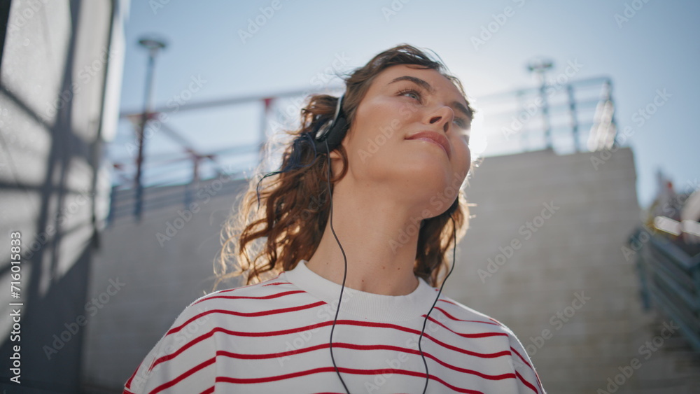 Headphone girl relaxing sunlight moving in tact song outdoors close up.