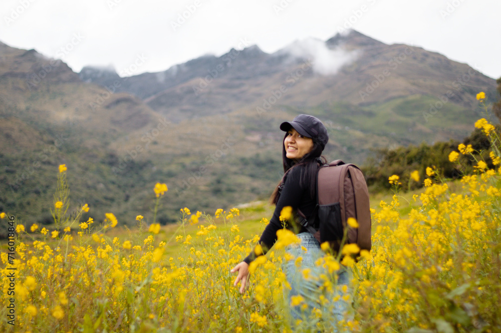 Exploradora de la naturaleza urbana Una chica atractiva con mochila entre flores amarillas. Estilo de vida, turista viajera Exploradora de la naturaleza urbana Una chica atractiva con mochila entre flores amarillas. Estilo de vida, turista viajera