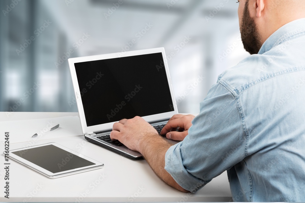 student or worker looking at laptop with a blank screen student or worker looking at laptop with a blank screen