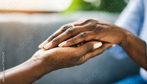 young woman and a senior lady, as they share a tender hand-holding moment, symbolizing intergenerational love and care © Your Hand Please