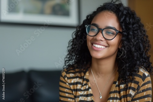 Young girl with afro hair with passionate look  sitting in her favorite cafe.