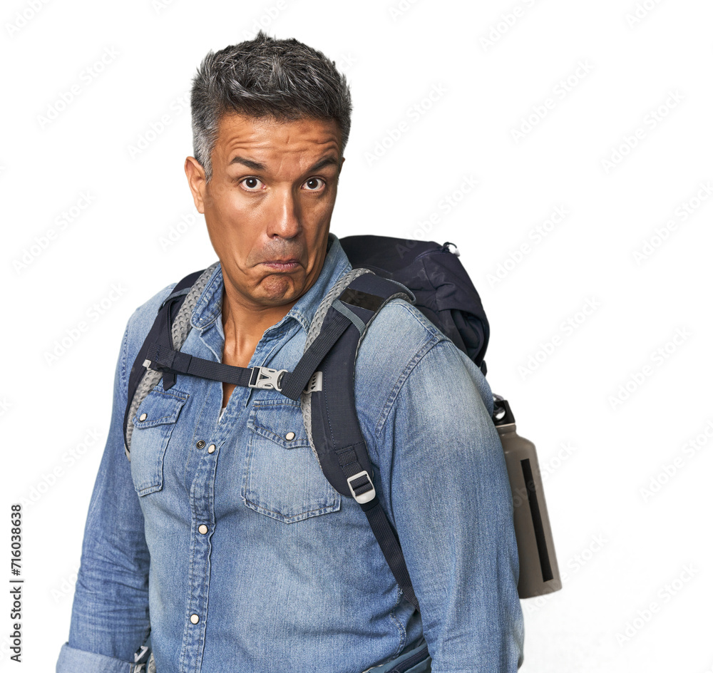 Hispanic hiker with backpack and flask shrugs shoulders and open eyes confused. Hispanic hiker with backpack and flask shrugs shoulders and open eyes confused.