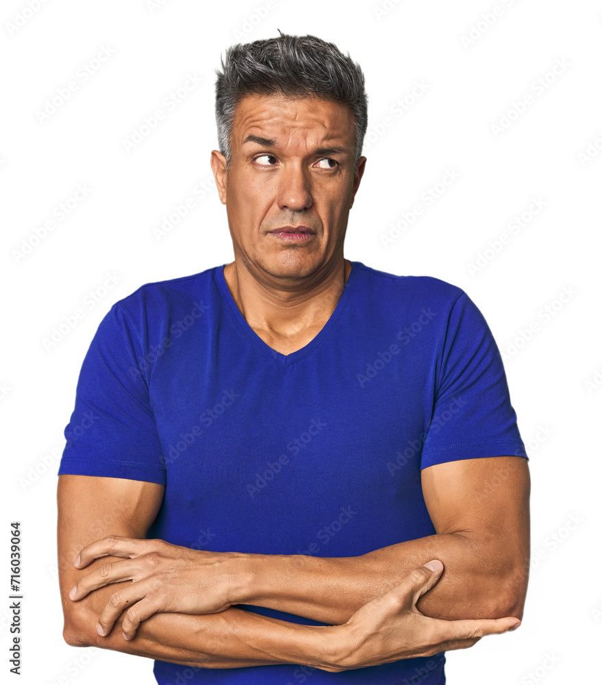 Fototapeta premium Middle-aged Latino man tired of a repetitive task.
