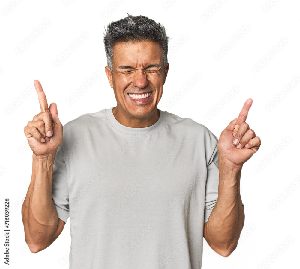 Middle-aged Latino man crossing fingers for having luck Middle-aged Latino man crossing fingers for having luck