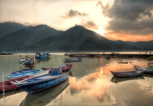 Sunset Scene with Still Fishing Boats with Pier and Mountains in Tung Chung, Hong Kong