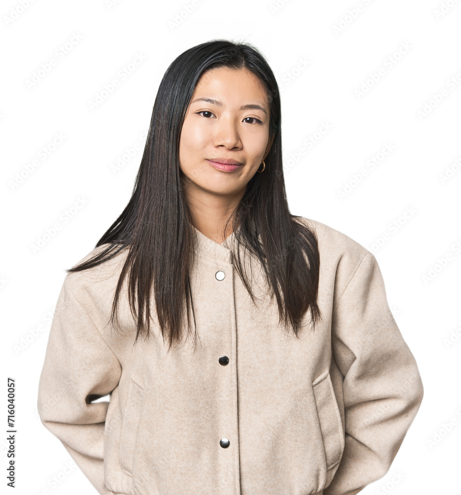 Young Chinese woman in studio setting happy, smiling and cheerful. Young Chinese woman in studio setting happy, smiling and cheerful.