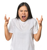 Young chinese woman isolated screaming with rage.