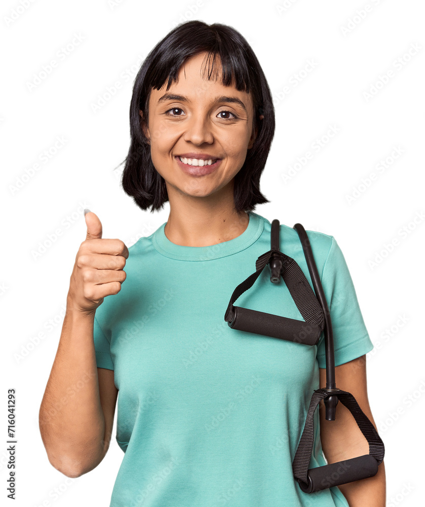 Young Hispanic athlete with resistance bands looks aside smiling, cheerful and pleasant. Young Hispanic athlete with resistance bands looks aside smiling, cheerful and pleasant.