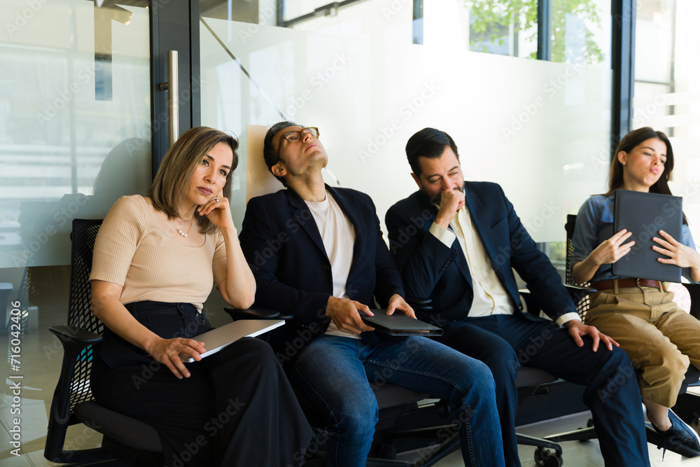 Restless group of job candidates waiting to get called for their interview Restless group of job candidates waiting to get called for their interview