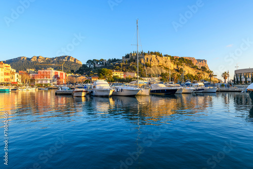 The Château de Cassis, the hilltop fortified castle, rises above the small marina at the old town of Cassis, France, along the Cote d'Azur French Riviera. photo