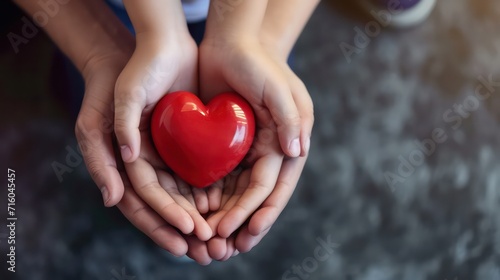 Young woman holding red heart, health insurance, donation, happy charity volunteer concept, world health day, world mental health day, world heart day photo