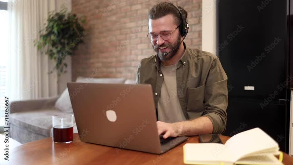 Mid adult man working as a call center dispatcher from home Mid adult man working as a call center dispatcher from home