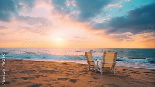 Two deck chairs for sunbathing on the beach, view at sunset. beautiful colorful sunset © @_ greta