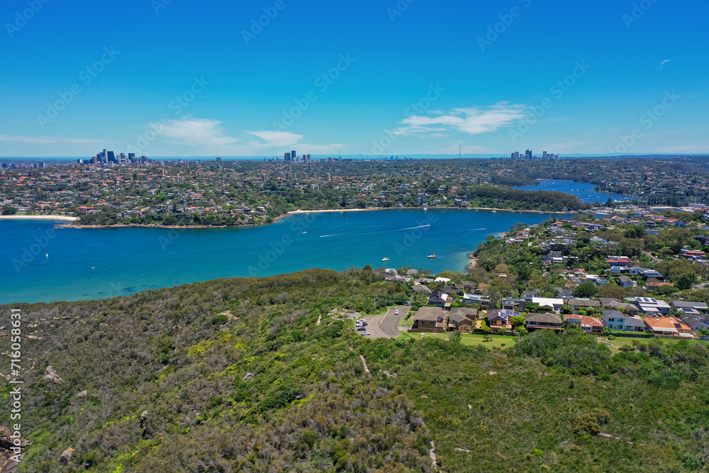 High angle aerial drone view of Edwards Beach and Chinamans Beach in the suburb of Mosman, Sydney, New South Wales, Australia. North Sydney, Chatswood in the background, Grotto Point in foreground.