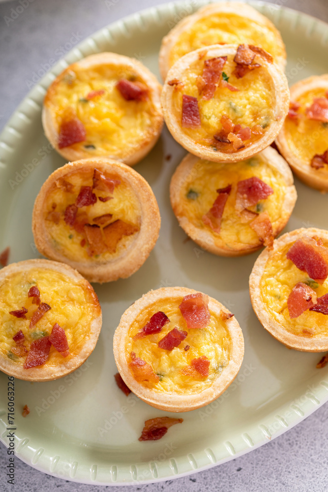 Mini quiches with ham and cheese topped with crispy bacon Mini quiches with ham and cheese topped with crispy bacon