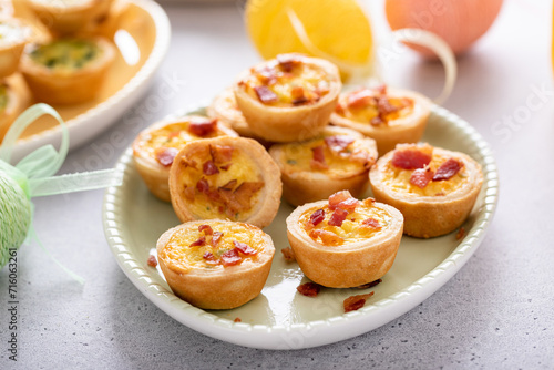 Mini quiches with ham and cheese topped with crispy bacon