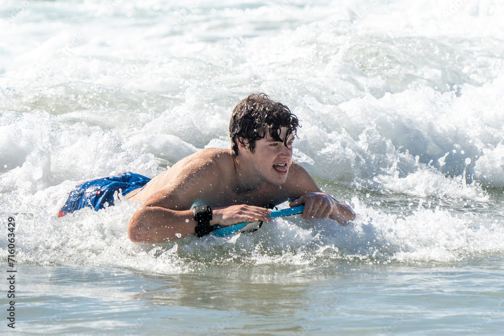 boogie boarding and playing in the water at Poipu beach