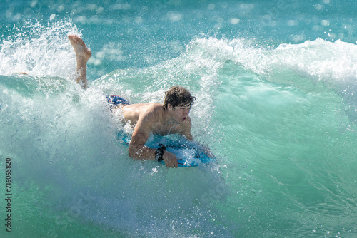 surfing on the beach in hawaii  © Allison