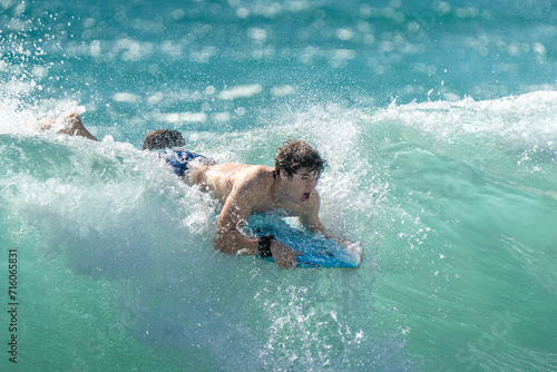 surfing on the beach in hawaii  © Allison
