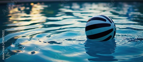 ball on the calm water of the courtyard pool at dusk photo