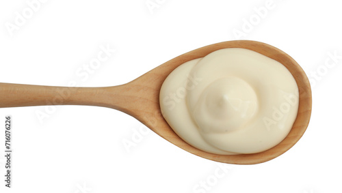 Fresh mayonnaise sauce in wooden spoon isolated on white, top view