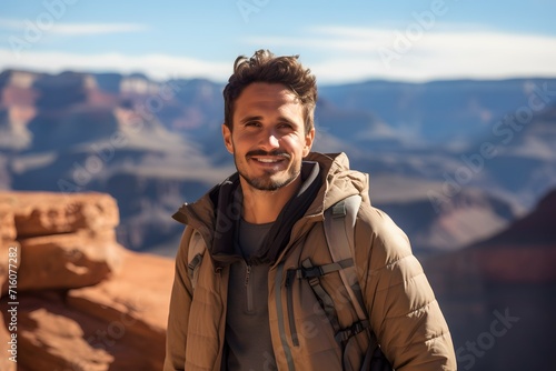 Male traveler with backpack on a scenic hike exploring dramatic canyon views